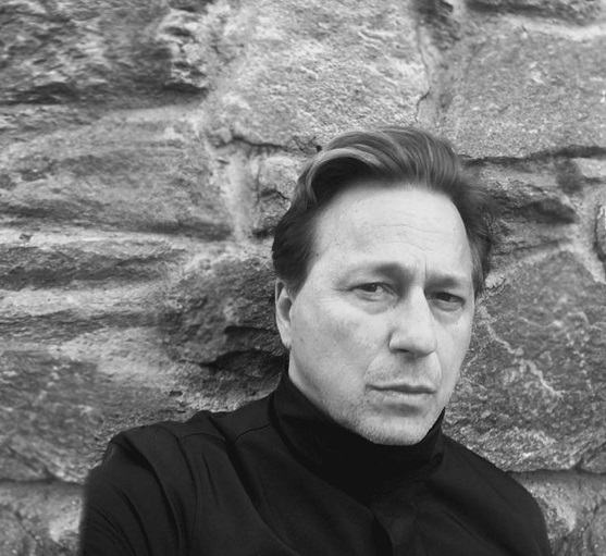 actor Jeff Wincott standing against a rock wall